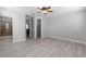 Light-filled main bedroom boasts wood-look floors and ensuite bathroom for added privacy at 1110 Terralago Way, Kissimmee, FL 34746