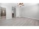 Light-filled main bedroom boasts wood-look floors and ensuite bathroom for added privacy at 1110 Terralago Way, Kissimmee, FL 34746