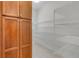 Pantry boasts ample storage space with built-in shelving and wooden cabinets at 1110 Terralago Way, Kissimmee, FL 34746