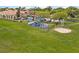 Community playground and picnic area nestled in a green lawn, offering a space for fun and relaxation at 1110 Terralago Way, Kissimmee, FL 34746