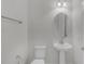 Powder room featuring a pedestal sink, mirror, and a toilet at 1110 Terralago Way, Kissimmee, FL 34746