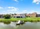 Waterfront home featuring a private boat dock, lush green lawn, and rear windows at 1110 Terralago Way, Kissimmee, FL 34746