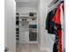 View of the walk-in closet with shelving units, drawers, and hanging rods at 1110 Terralago Way, Kissimmee, FL 34746