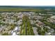 Aerial view of the community showcasing waterways, streets lined with trees, and a lake in the background at 121 Longview Ave, Celebration, FL 34747