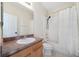 Bright bathroom featuring a shower-tub combo with a white shower curtain, tile floors, and single sink vanity at 121 Longview Ave, Celebration, FL 34747