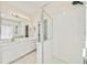 Bathroom featuring white cabinets, tile, a glass shower, and lighting above the mirror at 121 Longview Ave, Celebration, FL 34747