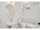 Bathroom features a pedestal sink, toilet, and tub with shower at 121 Longview Ave, Celebration, FL 34747