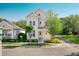 Charming two-story home featuring a covered front porch, landscaped yard, and inviting curb appeal at 121 Longview Ave, Celebration, FL 34747