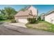 View of the house's exterior with a garage, driveway, and well-maintained lawn surrounded by green shrubs at 121 Longview Ave, Celebration, FL 34747
