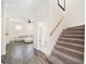 Open-concept living room with hardwood floors, a staircase, a half-bath, and comfortable furniture at 121 Longview Ave, Celebration, FL 34747