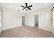 Large bedroom with ceiling fan, neutral carpet, and view into bathroom at 121 Longview Ave, Celebration, FL 34747