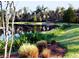 Scenic pond view with lush landscaping, foot bridge, and tranquil reflections of trees at 121 Longview Ave, Celebration, FL 34747