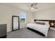 Cozy bedroom featuring a modern bed frame, stylish mirror, and neutral color scheme at 1219 Lido Dr, Howey In The Hills, FL 34737