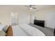 Bright bedroom featuring a ceiling fan, gray carpet, and a stylish black dresser at 1219 Lido Dr, Howey In The Hills, FL 34737