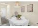 Cozy dining area with a round table, stylish light fixture, and contemporary decor at 1219 Lido Dr, Howey In The Hills, FL 34737