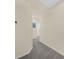 Hallway with neutral paint and gray carpeting at 1219 Lido Dr, Howey In The Hills, FL 34737