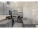 Spacious kitchen featuring granite countertops, stainless steel appliances, and sleek gray cabinetry at 1219 Lido Dr, Howey In The Hills, FL 34737
