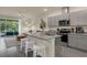 Modern kitchen with granite countertops, stainless steel appliances, and center island with bar stool seating at 1219 Lido Dr, Howey In The Hills, FL 34737