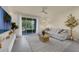 Inviting living room with sliding glass doors, neutral decor, and plenty of natural light at 1219 Lido Dr, Howey In The Hills, FL 34737