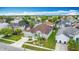 Aerial view showcases home's manicured front yard and surrounding community at 12445 Bohannon Blvd, Orlando, FL 32824