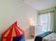 Playful bedroom with colorful accents, featuring a circus tent and a soft white dresser at 12445 Bohannon Blvd, Orlando, FL 32824