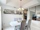 Elegant dining area with a chandelier, artwork and seating for four at 12445 Bohannon Blvd, Orlando, FL 32824