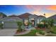 Charming single-story home boasts a well-manicured lawn and inviting front entrance with lush landscaping at 12445 Bohannon Blvd, Orlando, FL 32824