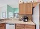 Well-lit kitchen featuring wood cabinets, stainless steel appliances, and a view to the living area at 12445 Bohannon Blvd, Orlando, FL 32824