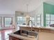 Kitchen sink with views of the backyard pool and open layout design at 12445 Bohannon Blvd, Orlando, FL 32824