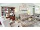 Inviting living room with a cozy furniture arrangement, natural light, and decorative bookshelf at 12445 Bohannon Blvd, Orlando, FL 32824