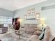 Spacious living room with comfortable seating, decorative shelves, and natural light at 12445 Bohannon Blvd, Orlando, FL 32824