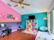 Bright, colorful living room features hardwood floors, modern decor, and fun color accents at 12445 Bohannon Blvd, Orlando, FL 32824