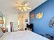Main bedroom featuring unique decor and artwork, with a glimpse into the en-suite bathroom at 12445 Bohannon Blvd, Orlando, FL 32824
