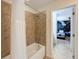 Bathroom with shower over tub and view into themed ' bedroom for fun Gathering living at 1614 Lima Ave, Kissimmee, FL 34747