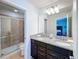 Bathroom with double vanity, granite countertop, shower, and tiled floor at 1614 Lima Ave, Kissimmee, FL 34747