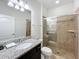 Bathroom featuring a glass shower door and granite countertops at 1614 Lima Ave, Kissimmee, FL 34747