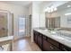 Bright bathroom with double vanity, granite countertop, and direct access to the backyard at 1614 Lima Ave, Kissimmee, FL 34747