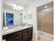 Bathroom featuring double sinks, granite countertops, and a shower at 1614 Lima Ave, Kissimmee, FL 34747