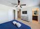 Bedroom featuring a queen-sized bed, television, and ensuite bathroom at 1614 Lima Ave, Kissimmee, FL 34747