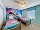 Themed ' bedroom with two twin beds and colorful wall decorations at 1614 Lima Ave, Kissimmee, FL 34747