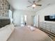 Bedroom featuring decorative ceiling fan, geometric patterned wallpaper, and luxury bedding at 1614 Lima Ave, Kissimmee, FL 34747