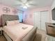 Bedroom featuring a queen-sized bed, ceiling fan, and large dresser at 1614 Lima Ave, Kissimmee, FL 34747
