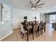 Dining room with a large wooden table, seating for eight, a modern light fixture, and access to the living area at 1614 Lima Ave, Kissimmee, FL 34747