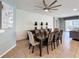 Modern dining room with elegant chairs, dark wood table and a decorative ceiling fan at 1614 Lima Ave, Kissimmee, FL 34747