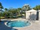 Relaxing hot tub surrounded by tropical landscaping and cabana area at 1614 Lima Ave, Kissimmee, FL 34747