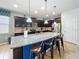Modern kitchen with breakfast bar seating at the island, dark wood cabinets, and tile backsplash at 1614 Lima Ave, Kissimmee, FL 34747