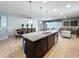 Open concept kitchen and dining area with a large island, seating, and modern decor at 1614 Lima Ave, Kissimmee, FL 34747