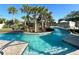 A winding lazy river with tropical landscaping and seating areas for relaxation at 1614 Lima Ave, Kissimmee, FL 34747