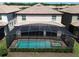 Rear exterior of home with screened-in pool and spa with a view of the backyard at 1614 Lima Ave, Kissimmee, FL 34747