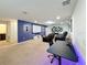 Finished basement with projector, screen, reclining seats, foosball, and desk at 1614 Lima Ave, Kissimmee, FL 34747